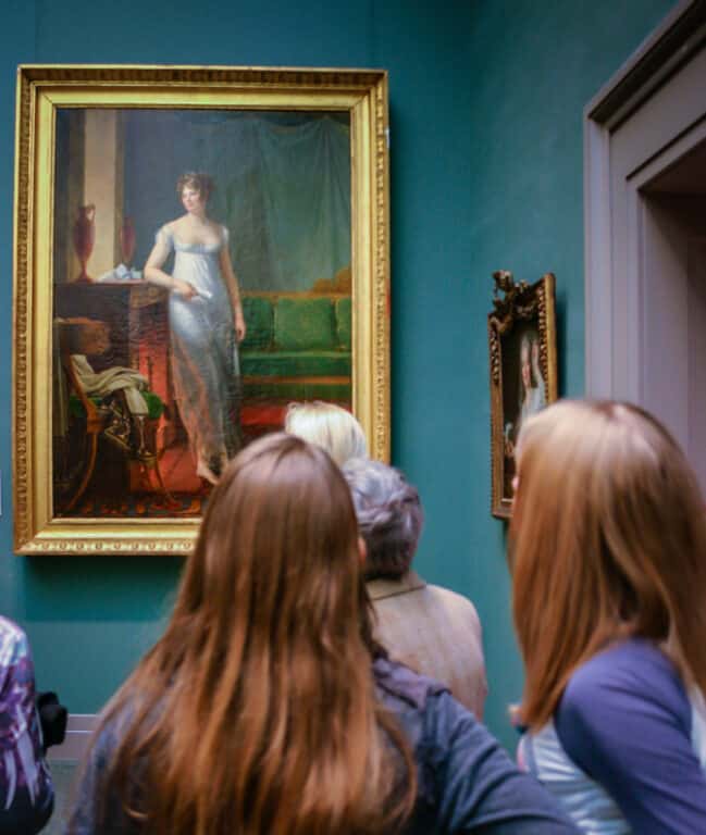 Patrons admire painting at the Met in NYC